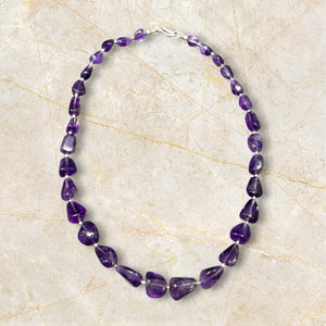 Striking but simple graduated boulder amethyst necklaces with sterling silver bead detailing, finished with a sterling silver hook clasp.