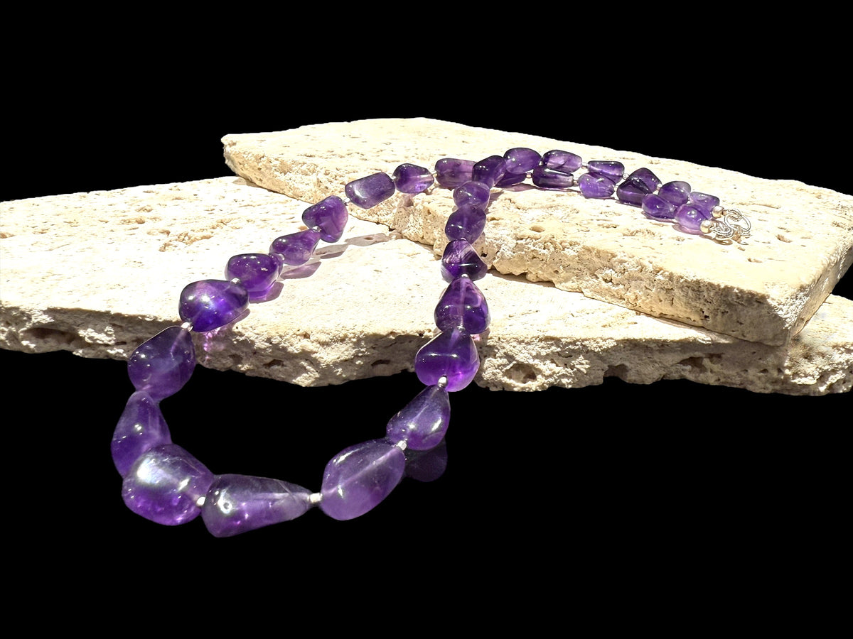 Striking but simple graduated boulder amethyst necklaces with sterling silver bead detailing, finished with a sterling silver hook clasp.
