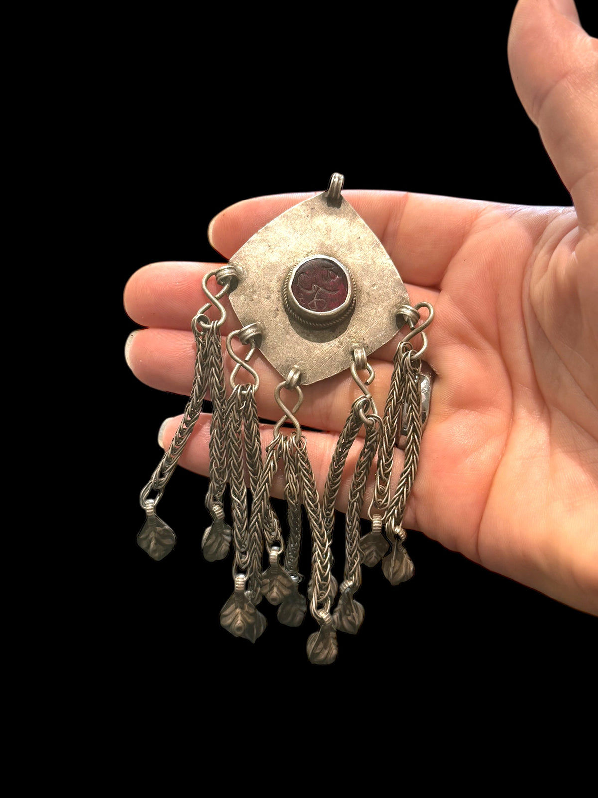 High grade silver plaque pendant with centre resin "gem" with unknown inscription, chains and leaf dangles. Afghanistan. Early to mid 20th century. Measurements: height 12 cm