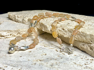 Long necklace made from apricot moonstone with handmade sterling silver Indian beads and centrepiece. A lovely necklace for any occasion. Length: 57.5 cm
