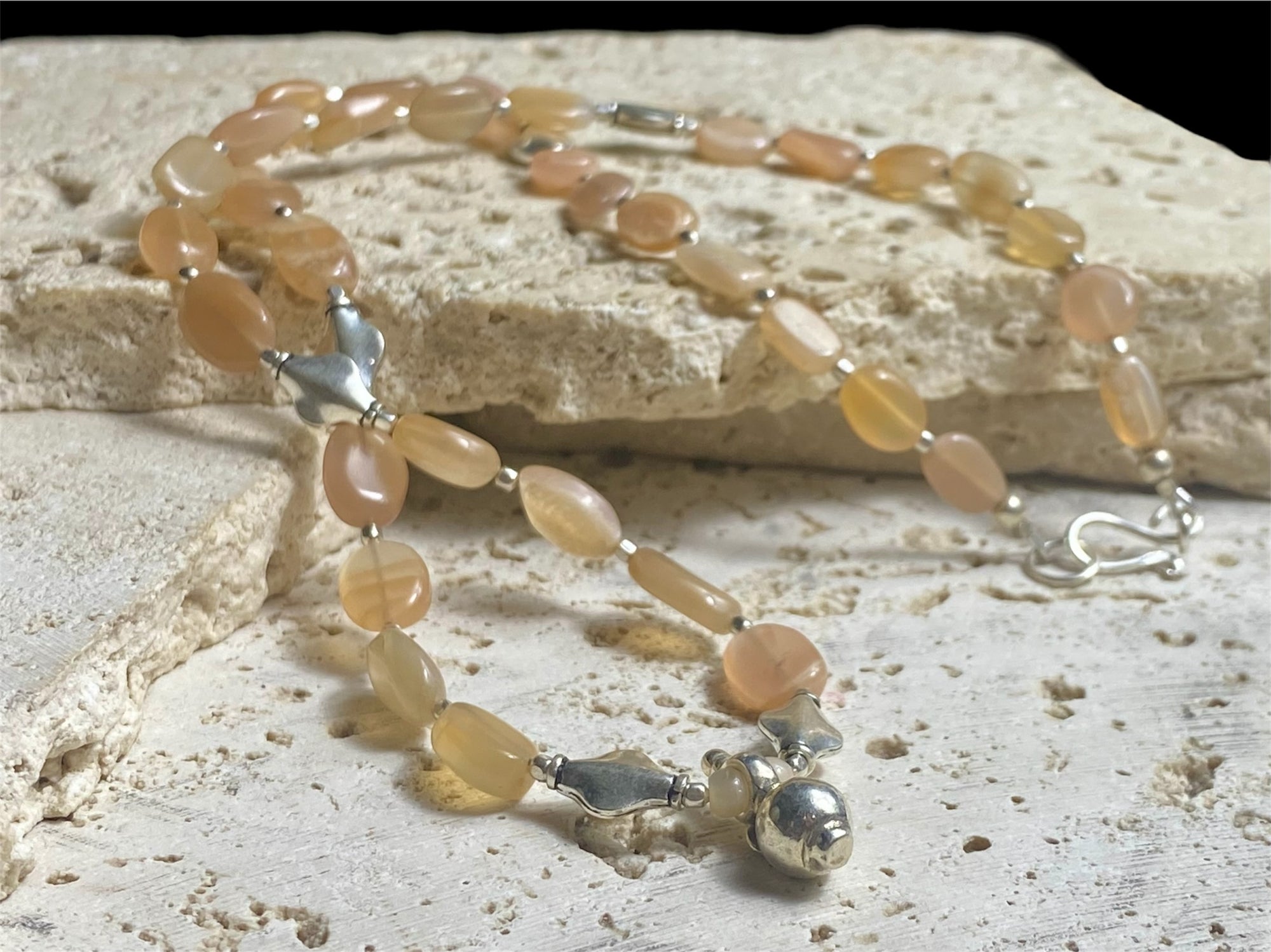 Long necklace made from apricot moonstone with handmade sterling silver Indian beads and centrepiece. A lovely necklace for any occasion. Length: 57.5 cm
