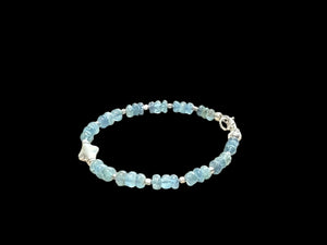 Fine beaded bracelet of aquamarine rondel beads, with a sterling silver feature bead, spacer beads & clasp. Length 16.5 cm, size 14 cm. Centre silver bead 1 cm