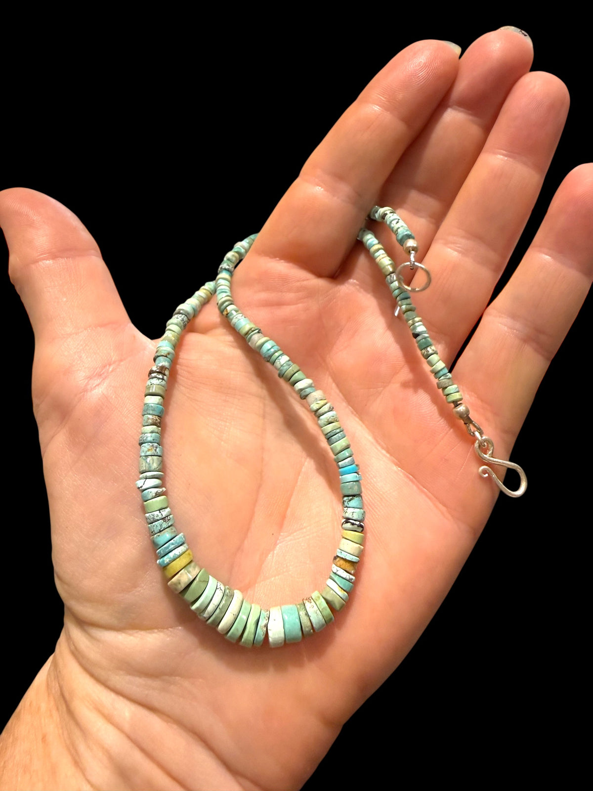 Graduated turquoise choker necklace featuring heshi beads of pale blue Arizona turquoise. Finished with a sterling silver hook clasp. 41 cm (16.25") length