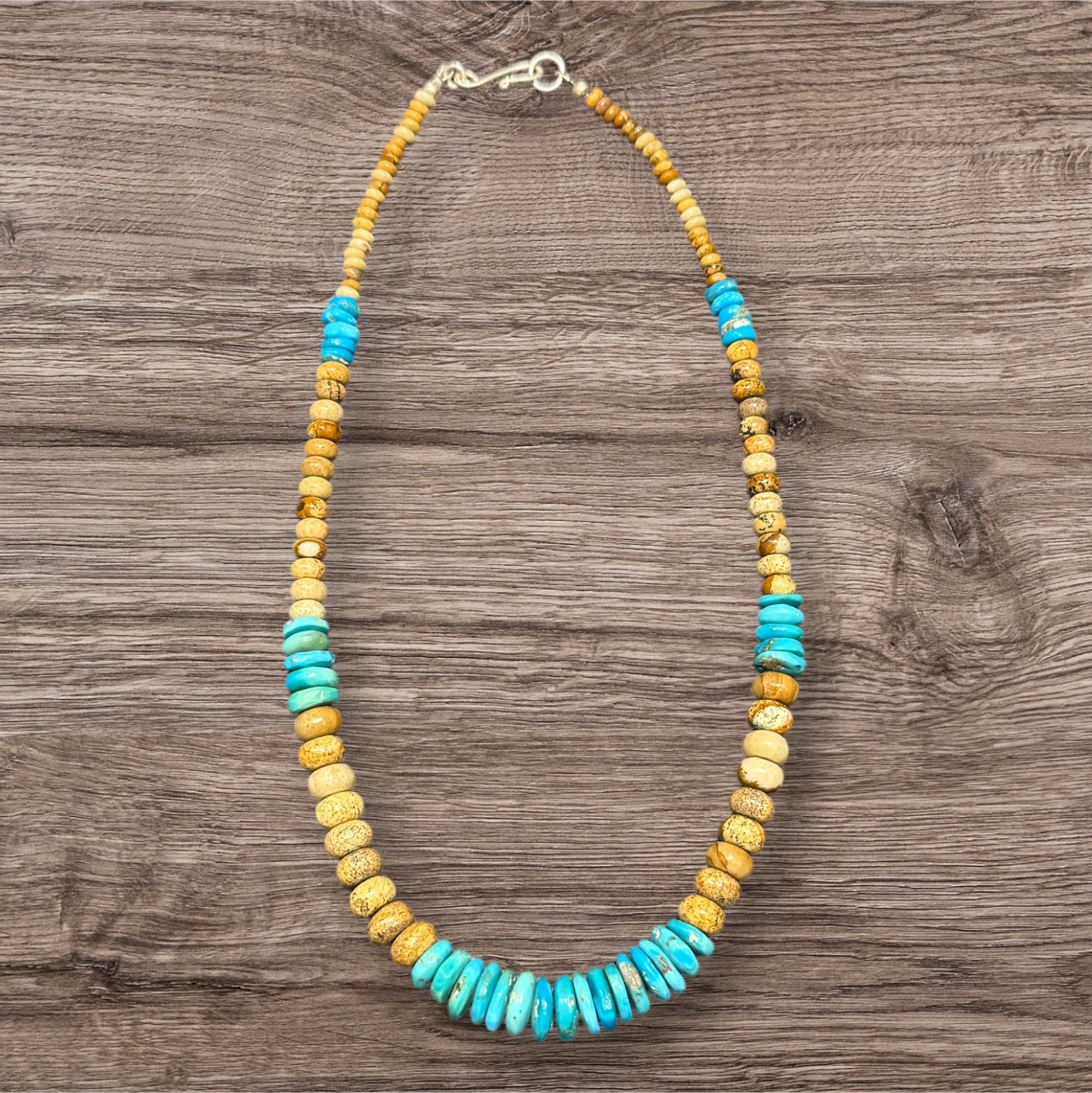 Southwest style necklace of graduated Arizonian turquoise & rondel cut jasper beads. The necklace is finished with a sterling silver hook clasp. Length 45.5 cm