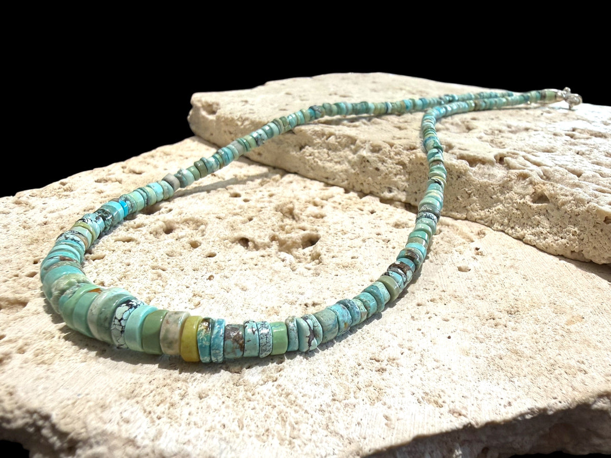 Graduated turquoise choker necklace featuring heshi beads of pale blue Arizona turquoise. Finished with a sterling silver hook clasp. 41 cm (16.25") length