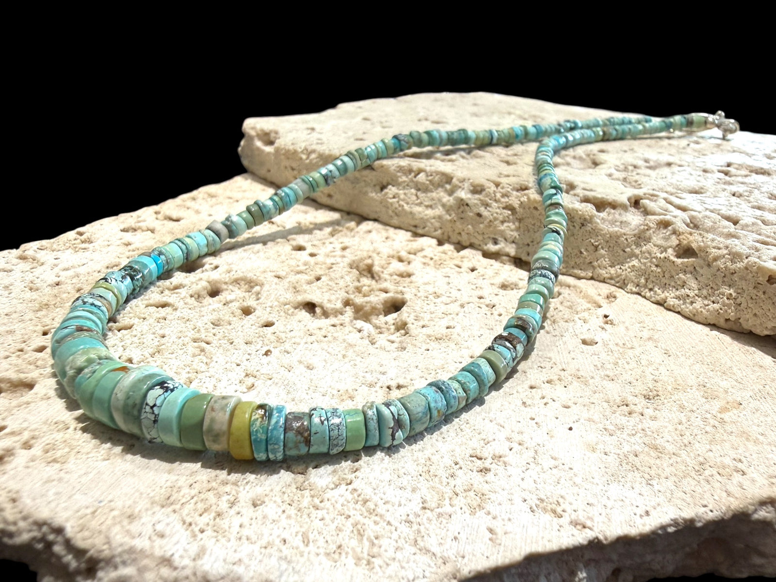 Graduated turquoise choker necklace featuring heshi beads of pale blue Arizona turquoise. Finished with a sterling silver hook clasp. 41 cm (16.25") length