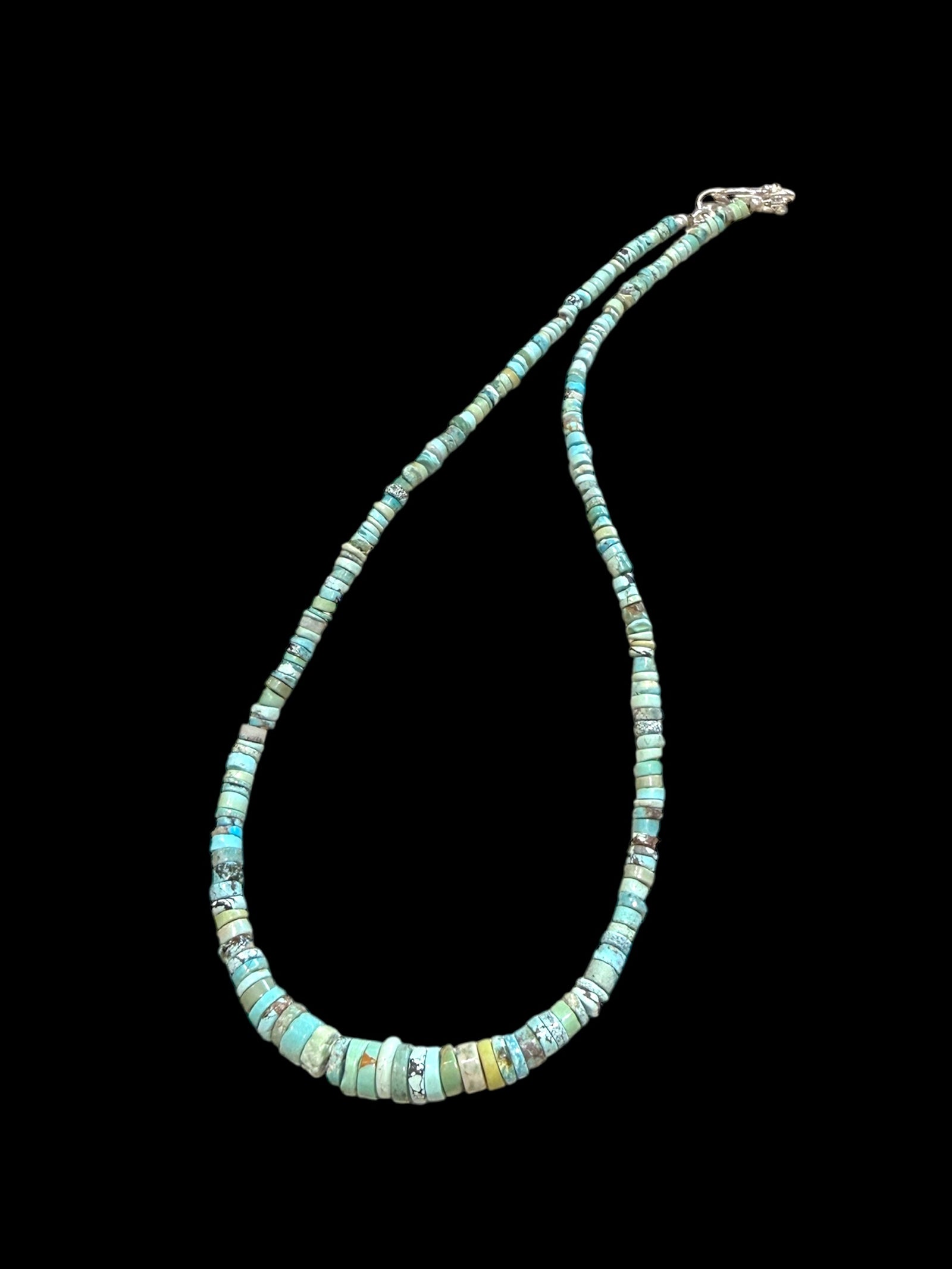 Graduated turquoise choker necklace featuring heshi beads of pale blue Arizona turquoise. Finished with a sterling silver hook clasp. 41 cm (16.25") length