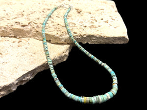 Graduated turquoise choker necklace featuring heshi beads of pale blue Arizona turquoise. Finished with a sterling silver hook clasp. 41 cm (16.25") length