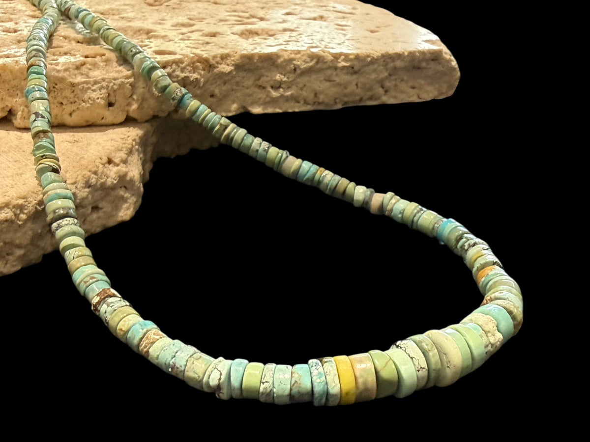 Graduated turquoise choker necklace featuring heshi beads of pale blue Arizona turquoise. Finished with a sterling silver hook clasp. 41 cm (16.25") length