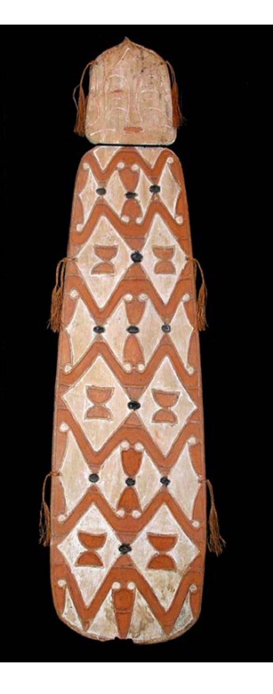 Asmat shield. Wood carved and decorated with lime, ochre, charcoal and sago fibre. Central Asmat region, Irian Jaya. Length 166 cm x 42 cm. Yartzhaus Collection