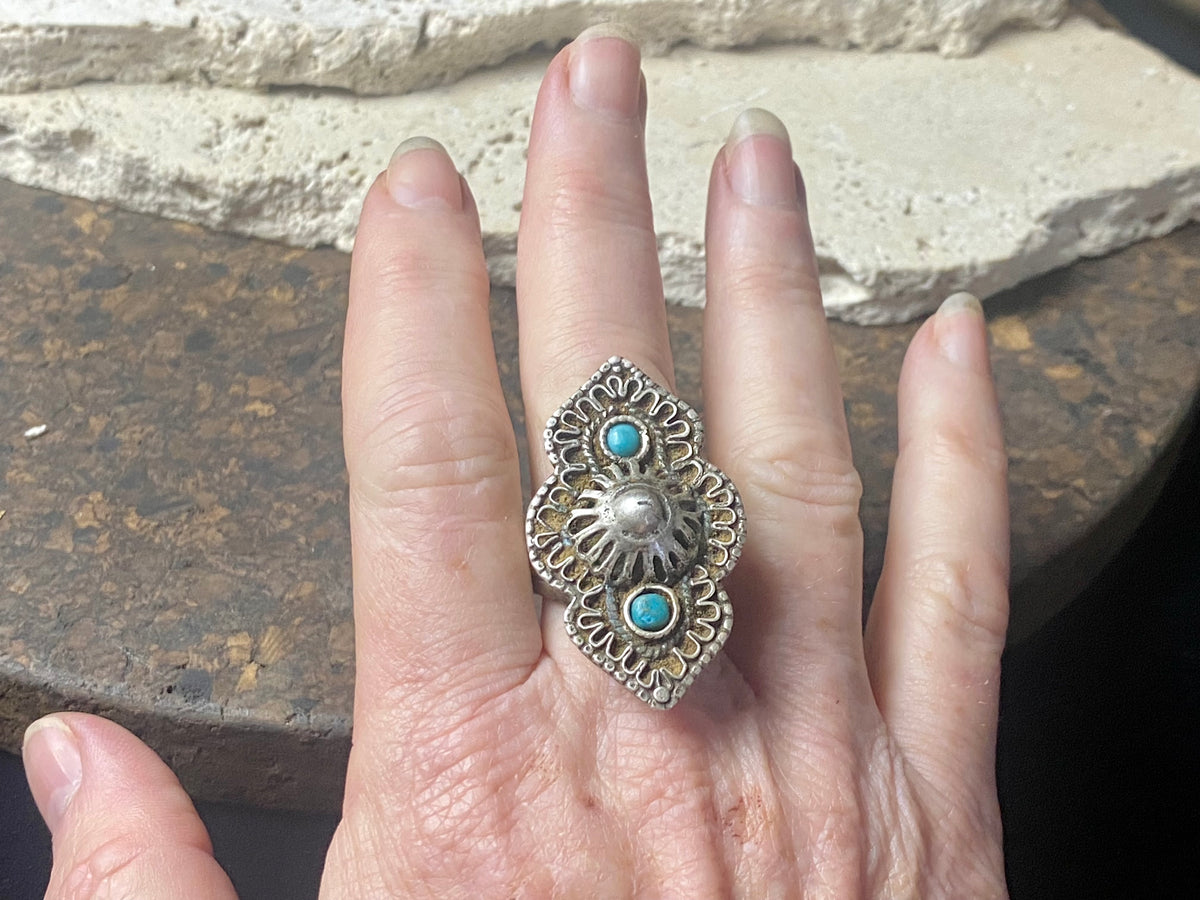 beautiful statement ring made by a Rajasthani village silversmith just outside of Jaipur. Sterling silver and blue ceramic beads with hand wired (not cast) filigree face decoration. Rajasthan, India. Looks great on a man's hand or woman's hand.   Measurements:  Face 4 cm x 2.5 cm Size 9.25 | 19.25 mm