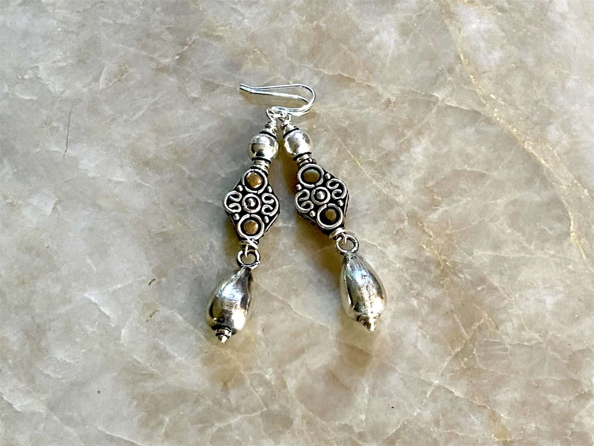 Lush baroque earrings are large in size but easy to wear. Sterling silver handmade beads, the centrepiece of which features gold look detailing in brass. Length including hook 6 cm