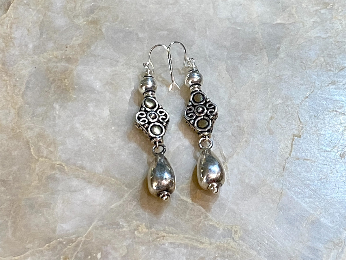 Lush baroque earrings are large in size but easy to wear. Sterling silver handmade beads, the centrepiece of which features gold look detailing in brass. Length including hook 6 cm
