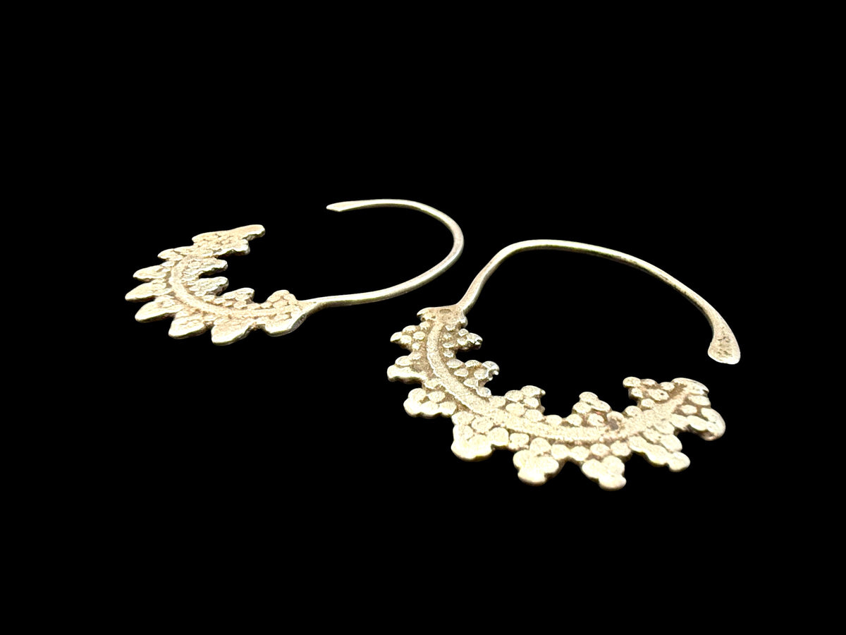 Berber hoop earrings with ornamented crescent edged with trefoil projections. High grade silver. Tunisia. Early 20th C or earlier. Width 3 cm, height 4.2 cm
