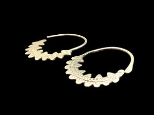 Berber open hoop earrings with ornamented crescent edged with trefoil projections. High grade silver. Tunisia. Early 20th C. Height 4.1 cm, width 3.7 cm
