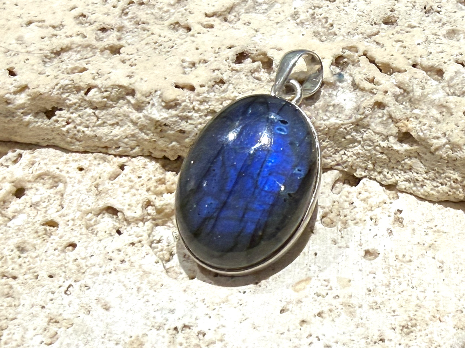 Large oval labradorite pendant set in sterling silver with a generous bail. A high set stone with excellent colour. Height 4.2 cm, width 2.3 cm, height 1 cm
