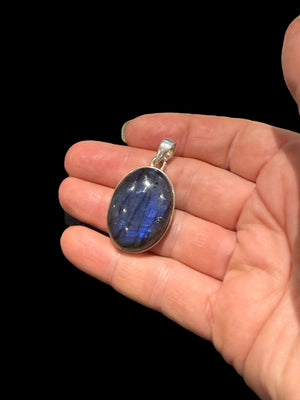 Large oval labradorite pendant set in sterling silver with a generous bail. A high set stone with excellent colour. Height 4.2 cm, width 2.3 cm, height 1 cm