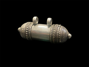 Amulet box, gau or prayer box pendant, these Buddhist or Hindu pendants open at one end and have plenty of room to place items inside. Two bails for a thick cord or chain. White metal with the look of silver. Length 6 cm, diameter 2 cm