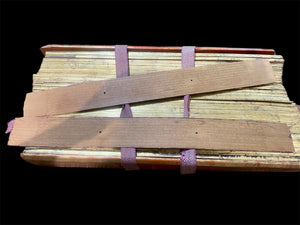 Palm leaf book, 19th century CE. Burma. Palm leaf, pigment and wood, lacquer and 24k gold gilding. Called a parabaik, the book contains hundreds of leaves bound by two flat woven cords between a pair of lacquered protective wood covers. The text is Pali, most likely religious. Measurements: Length 54 cm (21") x height 25 cm (9.75") x width 7 cm (2.75").