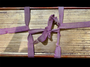 Palm leaf book, 19th century CE. Burma. Palm leaf, pigment and wood, lacquer and 24k gold gilding. Called a parabaik, the book contains hundreds of leaves bound by two flat woven cords between a pair of lacquered protective wood covers. The text is Pali, most likely religious. Measurements: Length 54 cm (21") x height 25 cm (9.75") x width 7 cm (2.75").