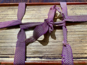 Palm leaf book, 19th century CE. Burma. Palm leaf, pigment and wood, lacquer and 24k gold gilding. Called a parabaik, the book contains hundreds of leaves bound by two flat woven cords between a pair of lacquered protective wood covers. The text is Pali, most likely religious. Measurements: Length 54 cm (21") x height 25 cm (9.75") x width 7 cm (2.75").