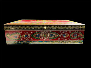 This charmingly painted box features one very large compartment and features a lid that is raised via hinges and. small brass knob as handle. The roominess of the box means it is perfect for holding everything from trinkets to watches, jewellery and keys. A lovely, hand painted piece of craftsmanship from Rajasthan, India.

Measurements: width 38, depth 25 cm, height 10 cm