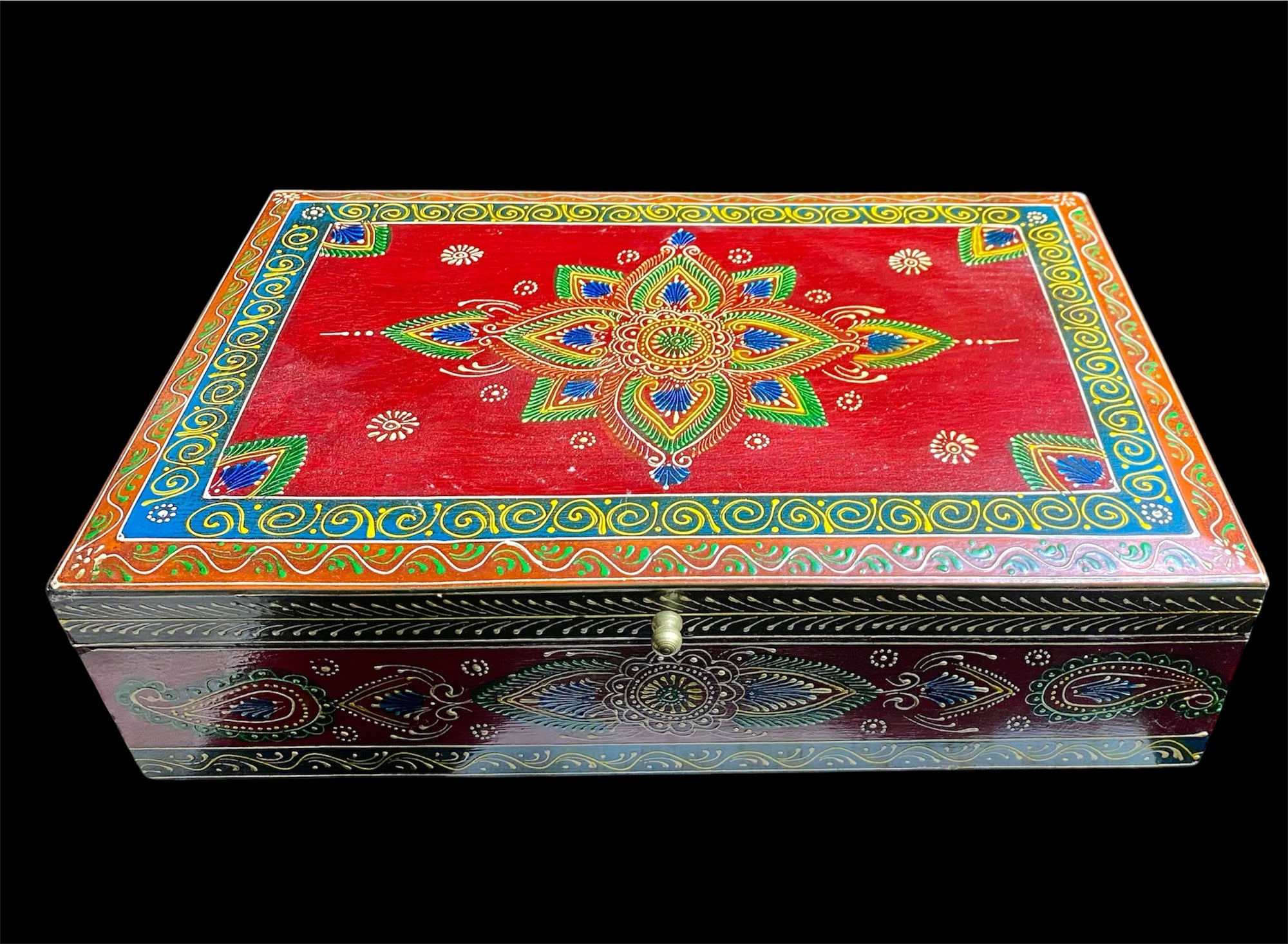 This charmingly painted box features one very large compartment and features a lid that is raised via hinges and. small brass knob as handle. The roominess of the box means it is perfect for holding everything from trinkets to watches, jewellery and keys. A lovely, hand painted piece of craftsmanship from Rajasthan, India.

Measurements: width 38, depth 25 cm, height 10 cm