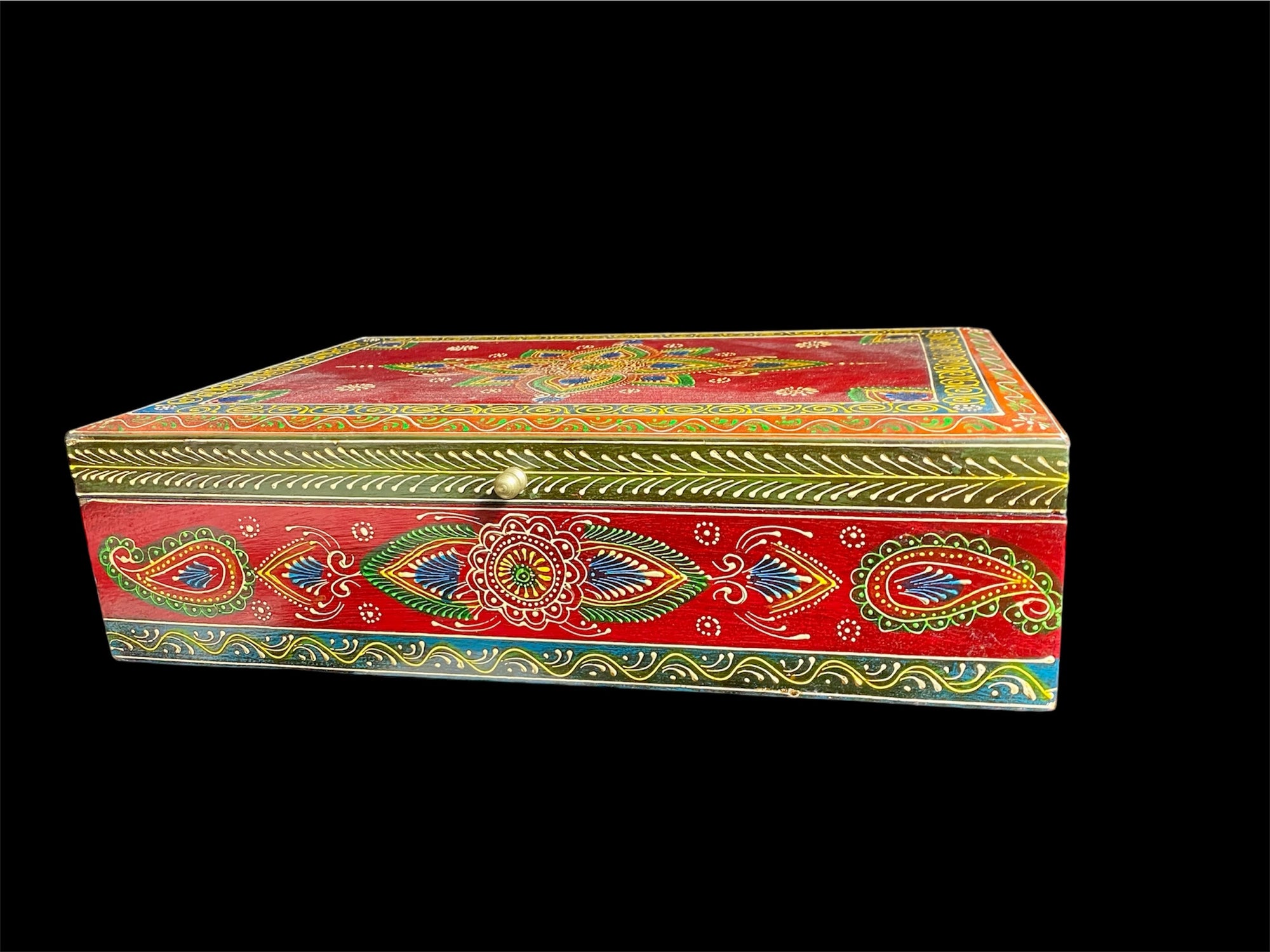 This charmingly painted box features one very large compartment and features a lid that is raised via hinges and. small brass knob as handle. The roominess of the box means it is perfect for holding everything from trinkets to watches, jewellery and keys. A lovely, hand painted piece of craftsmanship from Rajasthan, India.

Measurements: width 38, depth 25 cm, height 10 cm