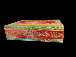 This charmingly painted box features one very large compartment and features a lid that is raised via hinges and. small brass knob as handle. The roominess of the box means it is perfect for holding everything from trinkets to watches, jewellery and keys. A lovely, hand painted piece of craftsmanship from Rajasthan, India.

Measurements: width 38, depth 25 cm, height 10 cm