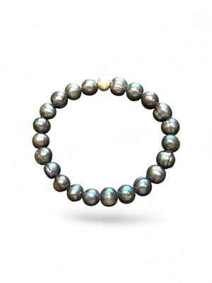 A simple and elegant bracelet of large black freshwater pearls and a single sterling silver bead. Elasticised stringing for a seamless look.