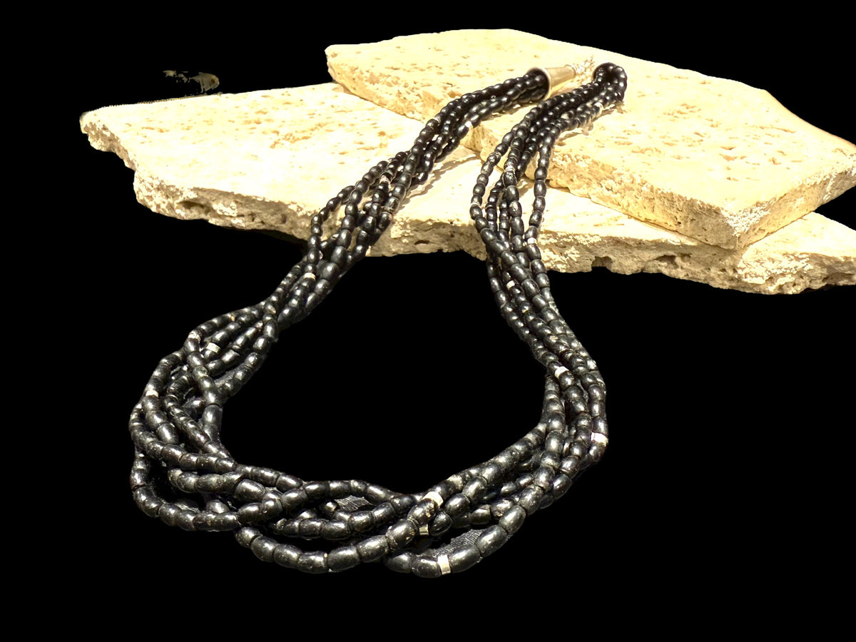 One of the oldest necklaces collected by Kashgar founder Bernie Heaphy, we've remade these strands into a very wearable necklace. Made by the Naga people of northeast India, these black ceramic beads have been teamed with sterling silver highlights and heavy sterling silver cone ends. Measurements: 57 cm length