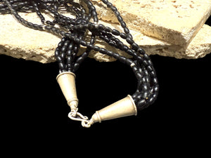 One of the oldest necklaces collected by Kashgar founder Bernie Heaphy, we've remade these strands into a very wearable necklace. Made by the Naga people of northeast India, these black ceramic beads have been teamed with sterling silver highlights and heavy sterling silver cone ends. Measurements: 57 cm length