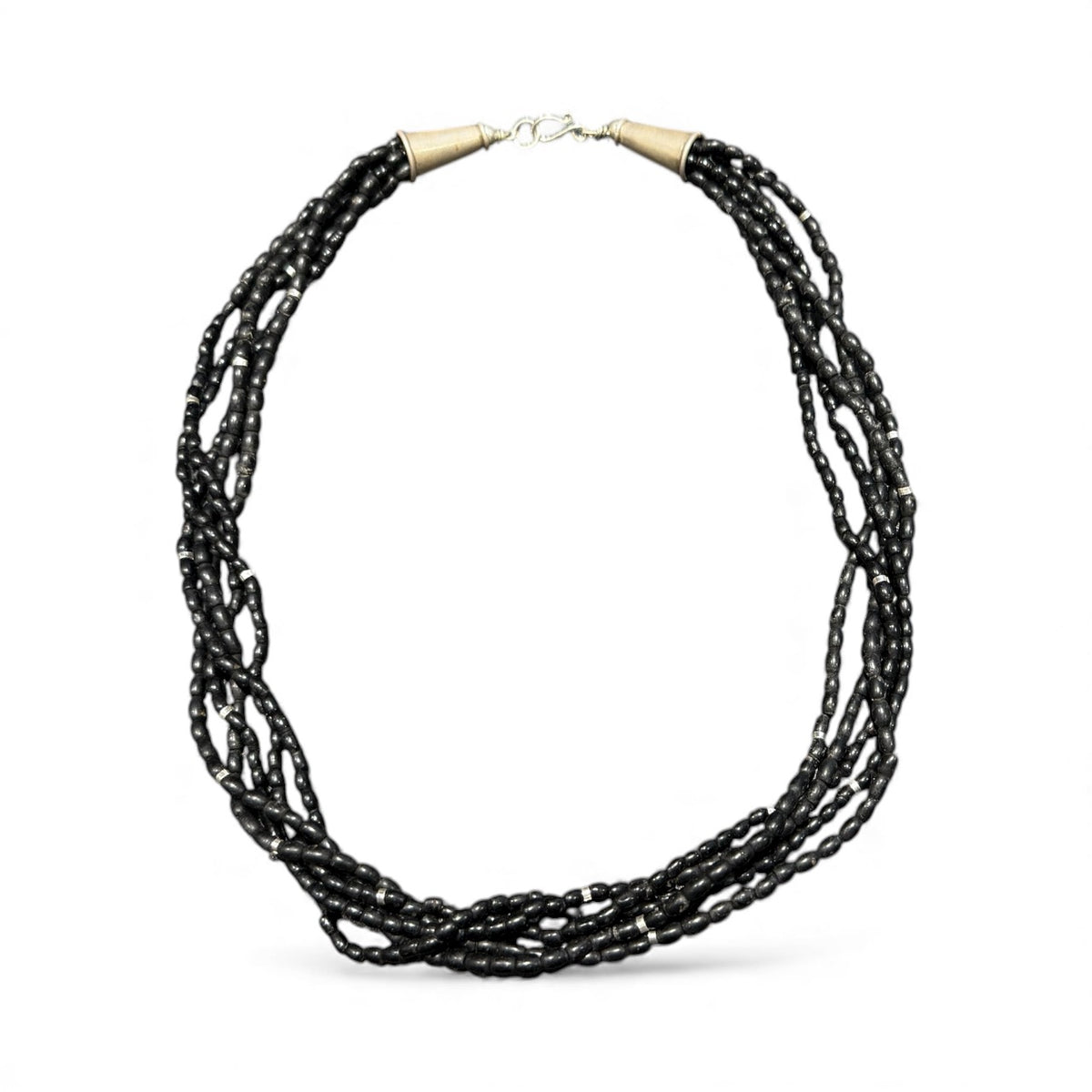 One of the oldest necklaces collected by Kashgar founder Bernie Heaphy, we've remade these strands into a very wearable necklace. Made by the Naga people of northeast India, these black ceramic beads have been teamed with sterling silver highlights and heavy sterling silver cone ends. Measurements: 57 cm length