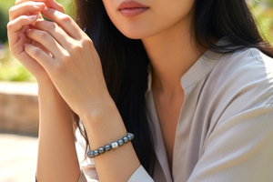 A simple and elegant bracelet of large black freshwater pearls and a single sterling silver bead. Elasticised stringing for a seamless look.