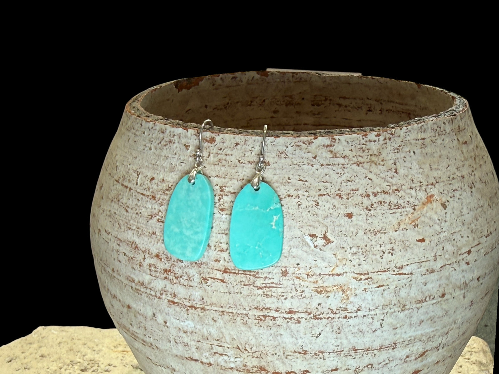 Elegant earrings of hand cut turquoise-dyed howlite stone, finished with sterling silver mounts and hooks. Length including hook 3.6 - 3.9 cm.