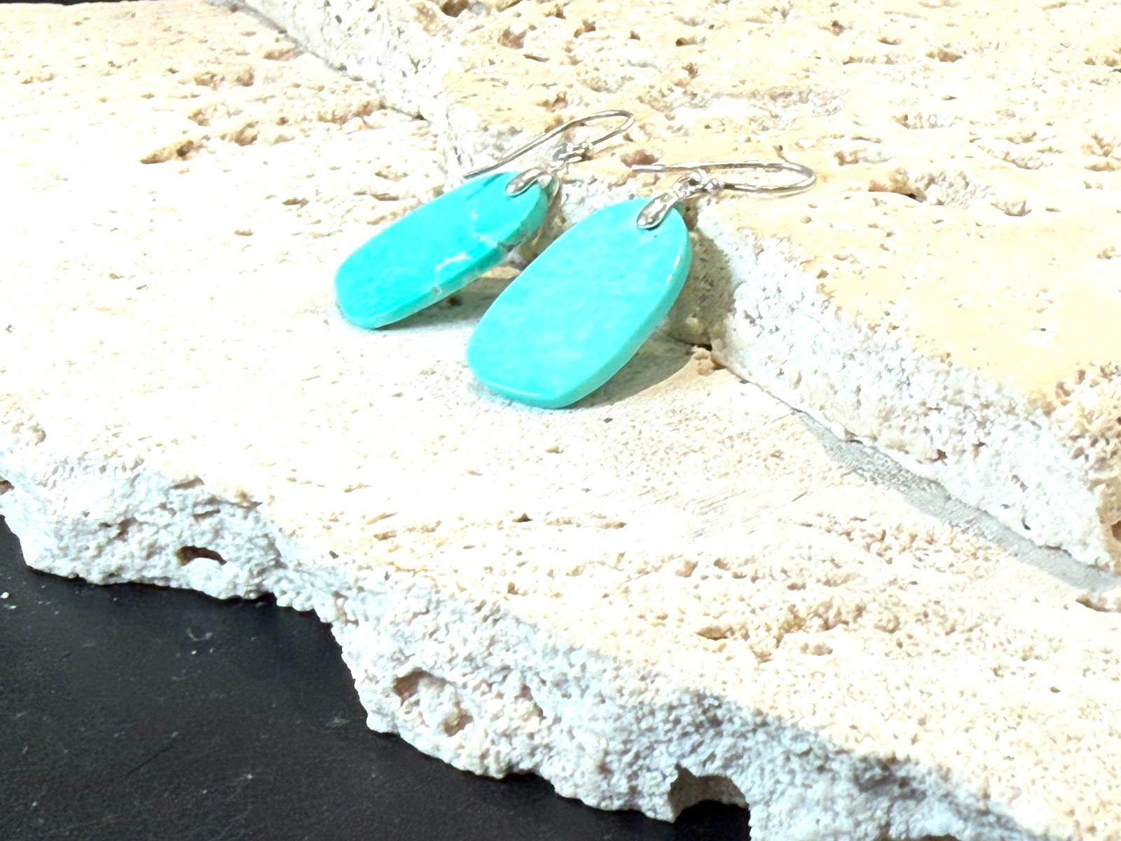 Elegant earrings of hand cut turquoise-dyed howlite stone, finished with sterling silver mounts and hooks. Length including hook 3.6 - 3.9 cm.