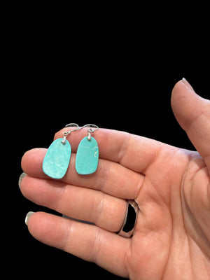 Elegant earrings of hand cut turquoise-dyed howlite stone, finished with sterling silver mounts and hooks. Length including hook 3.6 - 3.9 cm.