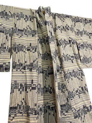 Vintage man or woman's  full length Japanese kimono dateing to the 1950s. Silk, hand stitched. Blue black geometric pattern on a cream background.