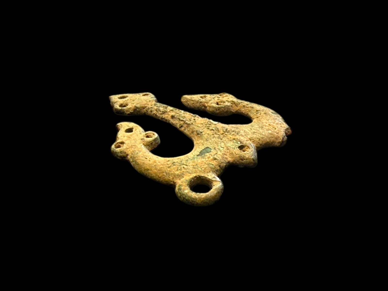 Decorative flat cast tri-lobed bronze mount, Herat region. c 10th - 13th CE. Used to decorate a leather or fabric belt or harness. Length 6.1 cm, width 5 cm.