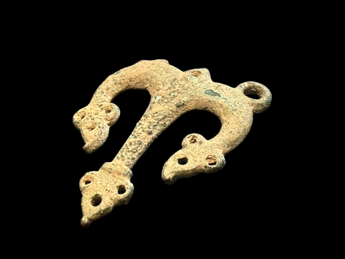 Decorative flat cast tri-lobed bronze mount, Herat region. c 10th - 13th CE. Used to decorate a leather or fabric belt or harness. Length 6.1 cm, width 5 cm.