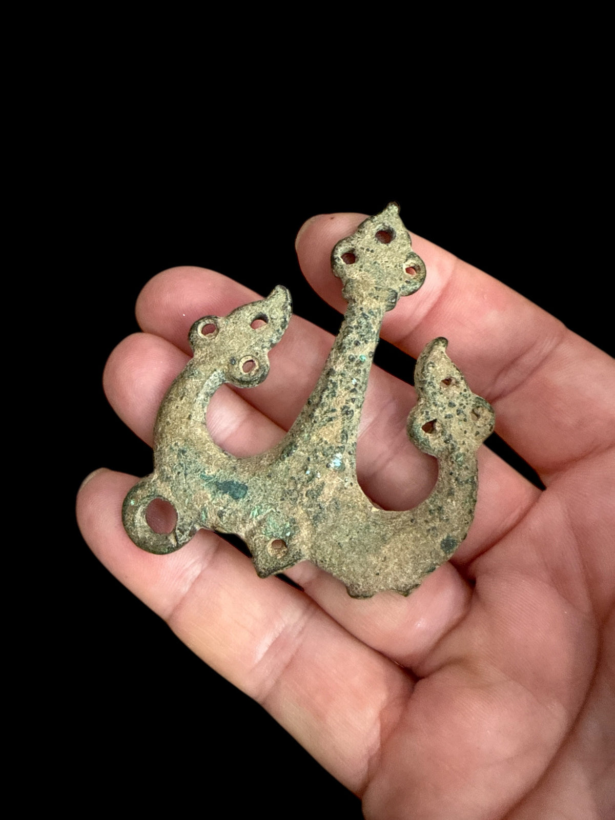 Decorative flat cast tri-lobed bronze mount, Herat region. c 10th - 13th CE. Used to decorate a leather or fabric belt or harness. Length 6.1 cm, width 5 cm.