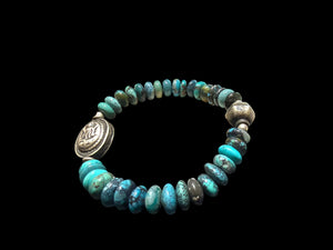 Turquoise with a silver Kali bead and a vintage silver bead as a counterpoint on the opposite side of the bracelet. Elasticised. Length 18 cm