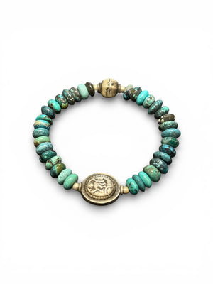 Turquoise with a silver Kali bead and a vintage silver bead as a counterpoint on the opposite side of the bracelet. Elasticised. Length 18 cm