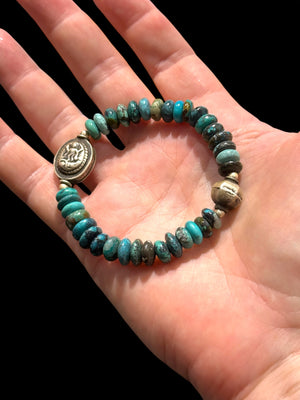 Turquoise with a silver Kali bead and a vintage silver bead as a counterpoint on the opposite side of the bracelet. Elasticised. Length 18 cm