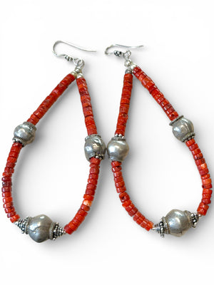 Long, bold southwest earrings of heshi coral highlighted with antique silver Rabari beads, sterling silver beads and hooks. Natural, sustainable bamboo coral, 10.5 cm length