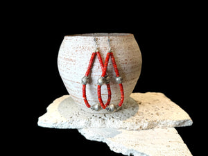 Long, bold southwest earrings of heshi coral highlighted with antique silver Rabari beads, sterling silver beads and hooks. Natural, sustainable bamboo coral, 10.5 cm length