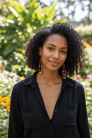 Long, bold southwest earrings of heshi coral highlighted with antique silver Rabari beads, sterling silver beads and hooks. Natural, sustainable bamboo coral, 10.5 cm length