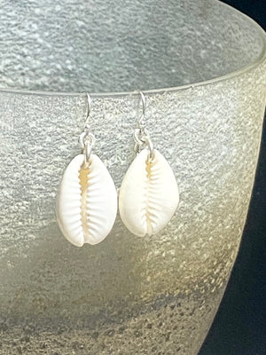 Simple cowrie shell earrings finished with sterling silver mounts and hooks. Measurements: length including hook 3.5 cm