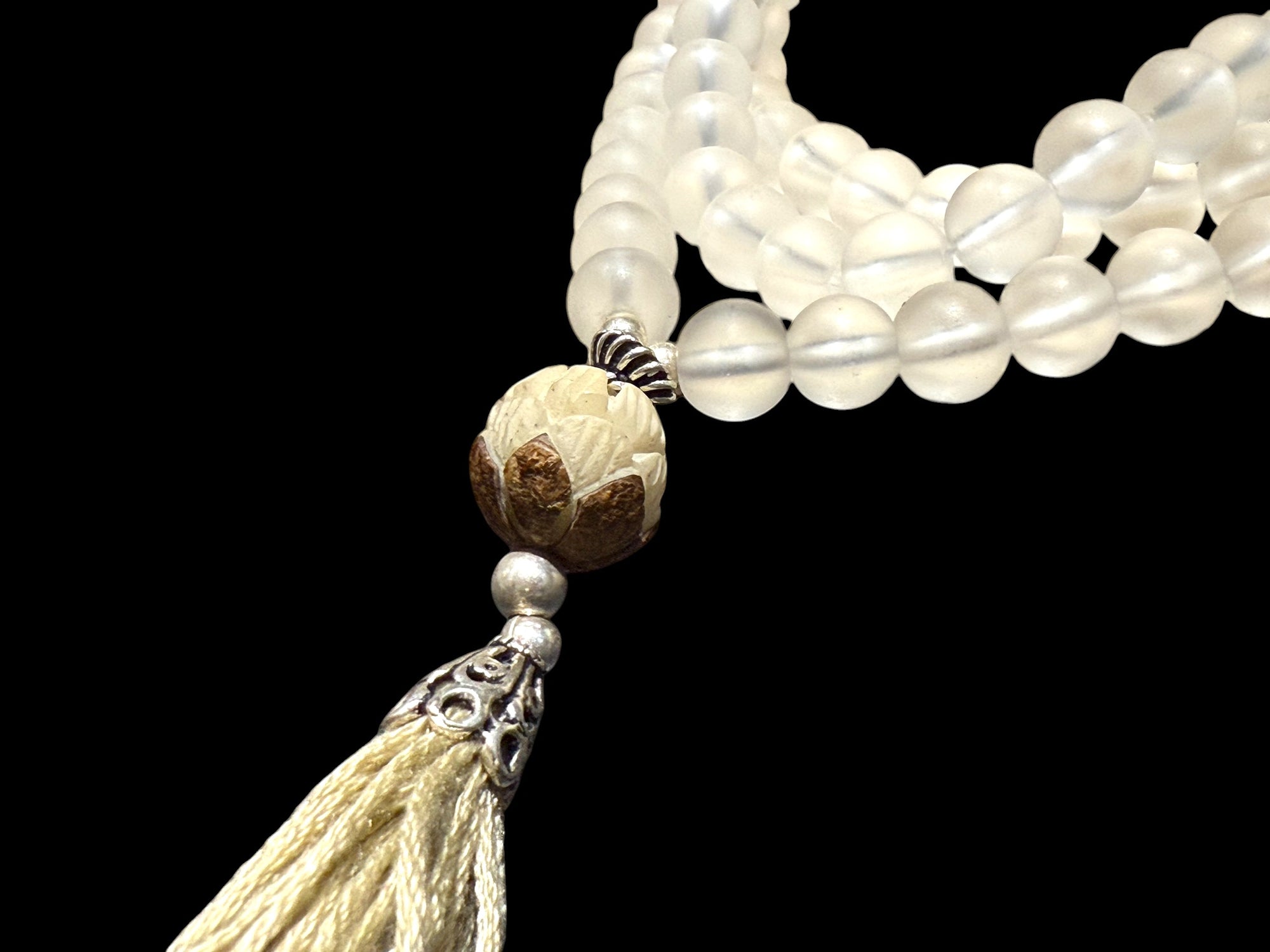Mala prayer bead necklace of 108 beads. Crystal beads are highlighted with a carved lotus root and sterling silver tassel. 80 cm length, pendant 13 cm.