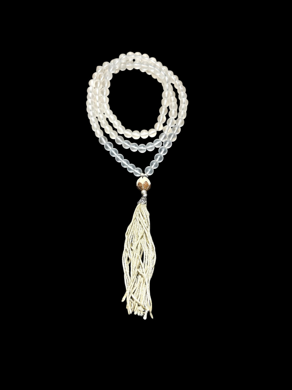 Mala prayer bead necklace of 108 beads. Crystal beads are highlighted with a carved lotus root and sterling silver tassel. 80 cm length, pendant 13 cm.
